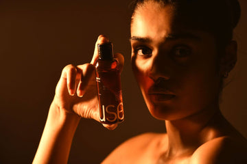 Woman holding bottle of relaxing massage oil