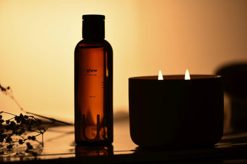 Massage oil and candle in dim light