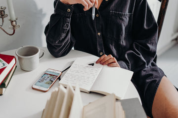  A person journaling at a table