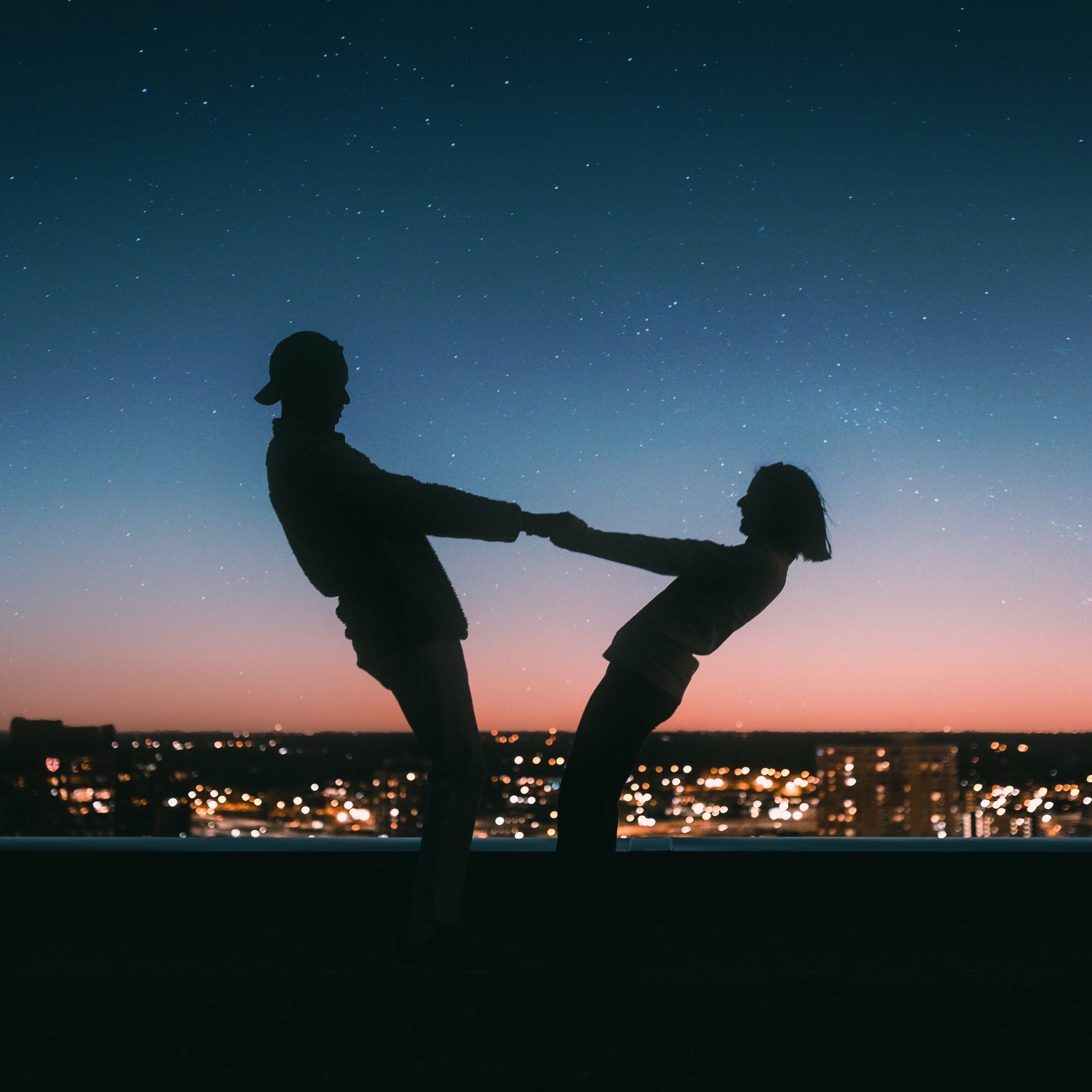 Couple holding hands on the roof 