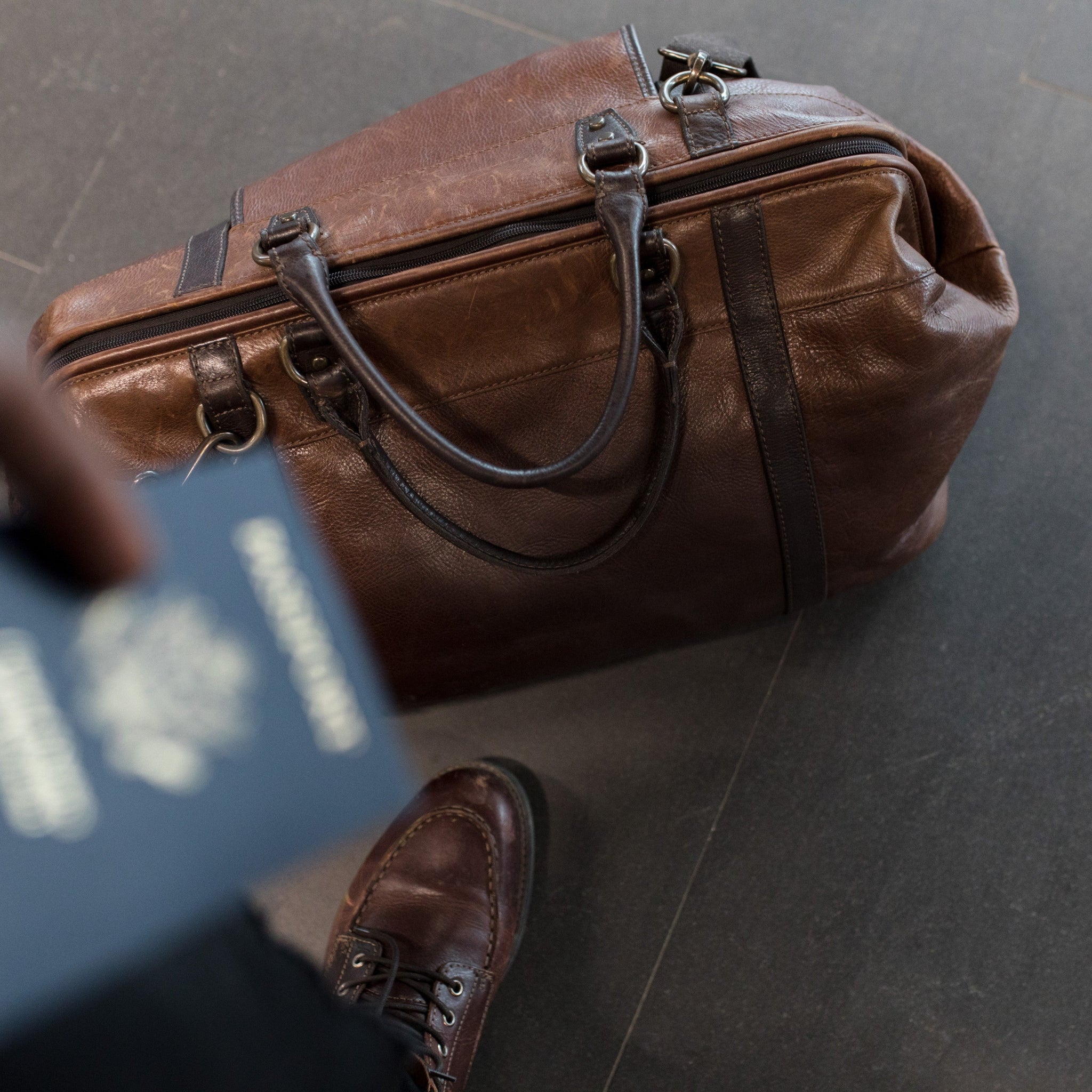 Man standing with a bag and passport