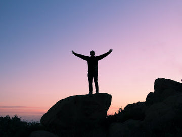 Man standing on the top of a rock