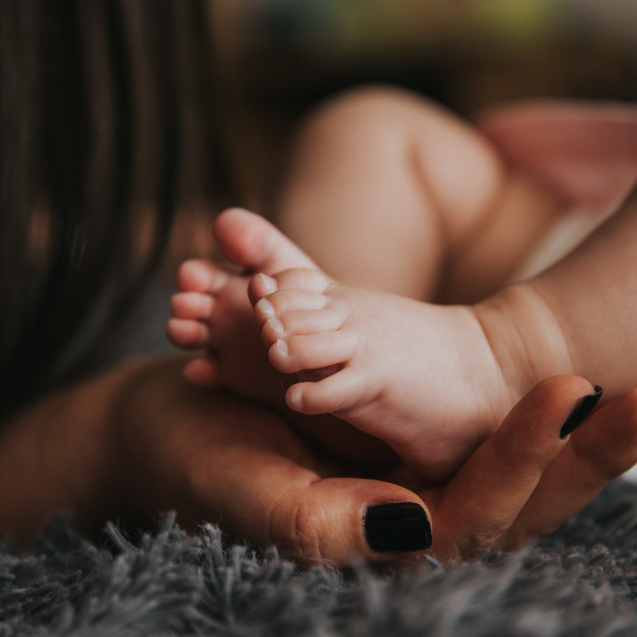 New mom holding her baby's feet