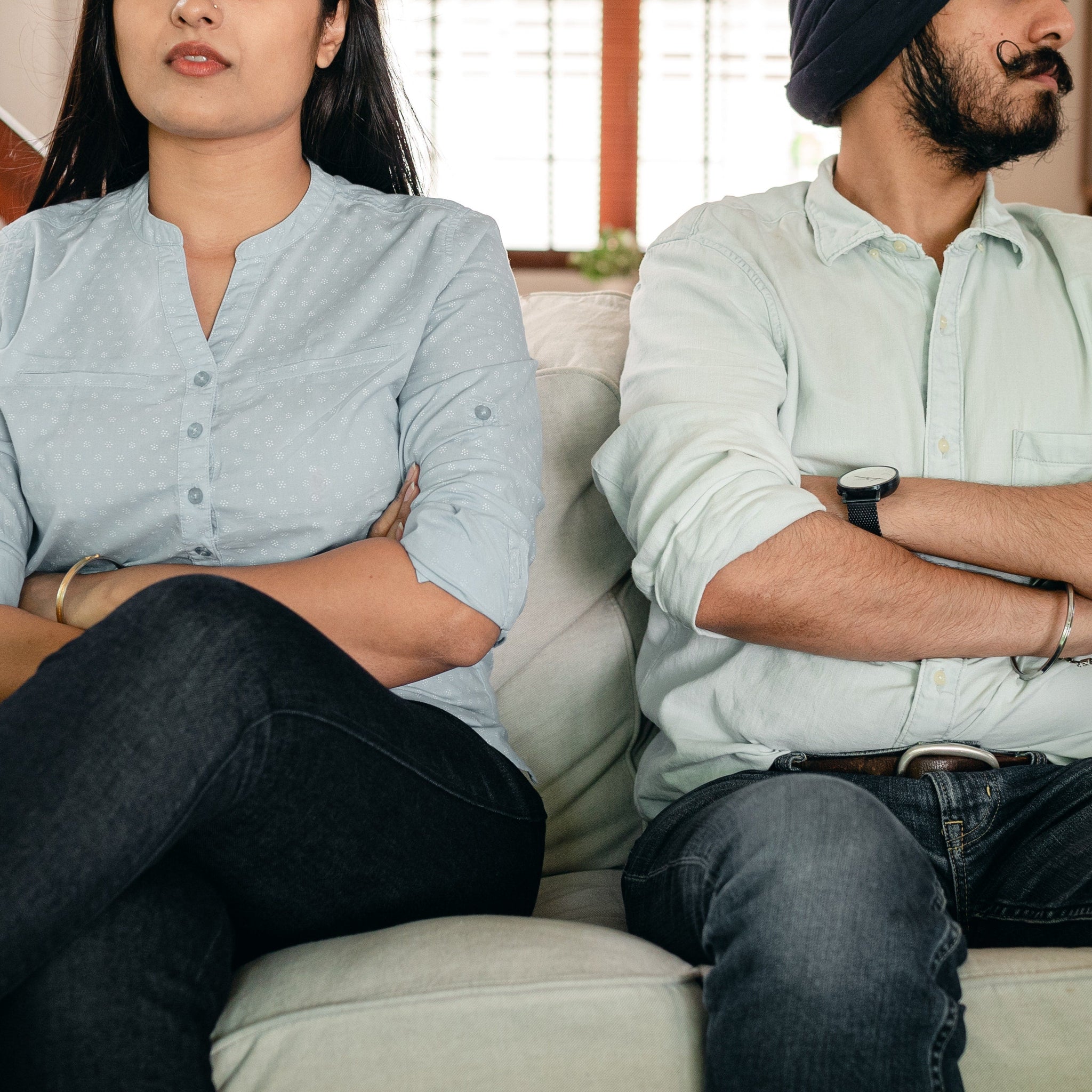 Couple sitting on a sofa having marriage issues