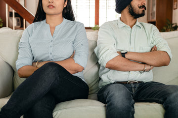 Couple sitting on a sofa having marriage issues