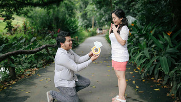 A Man Proposing to a Woman Using a Giant Paper Ring