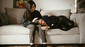 Two women sitting on a sofa