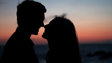  Silhouette of a man and a woman about to kiss