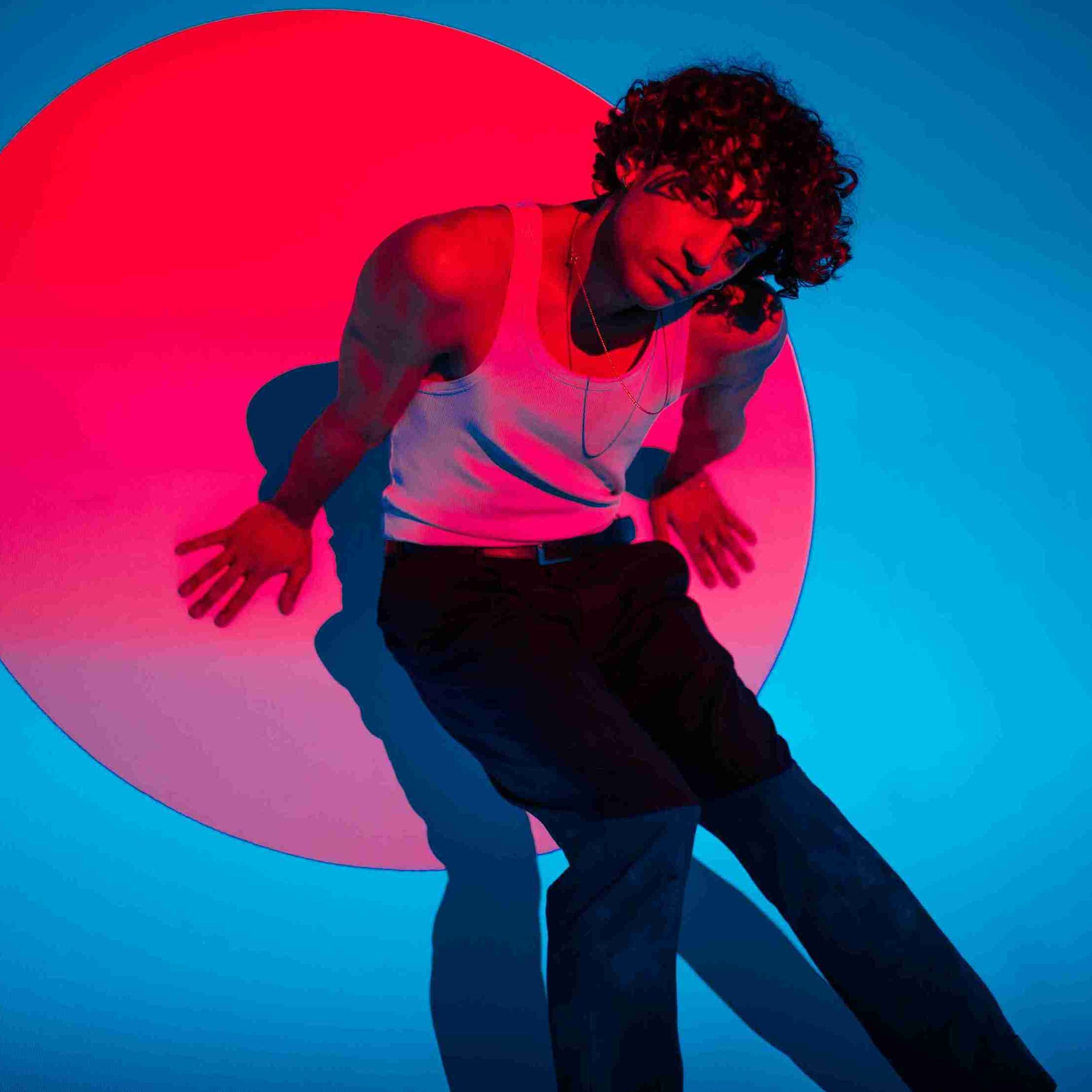  Man in White Tank Top With Red Light Reflection On Face