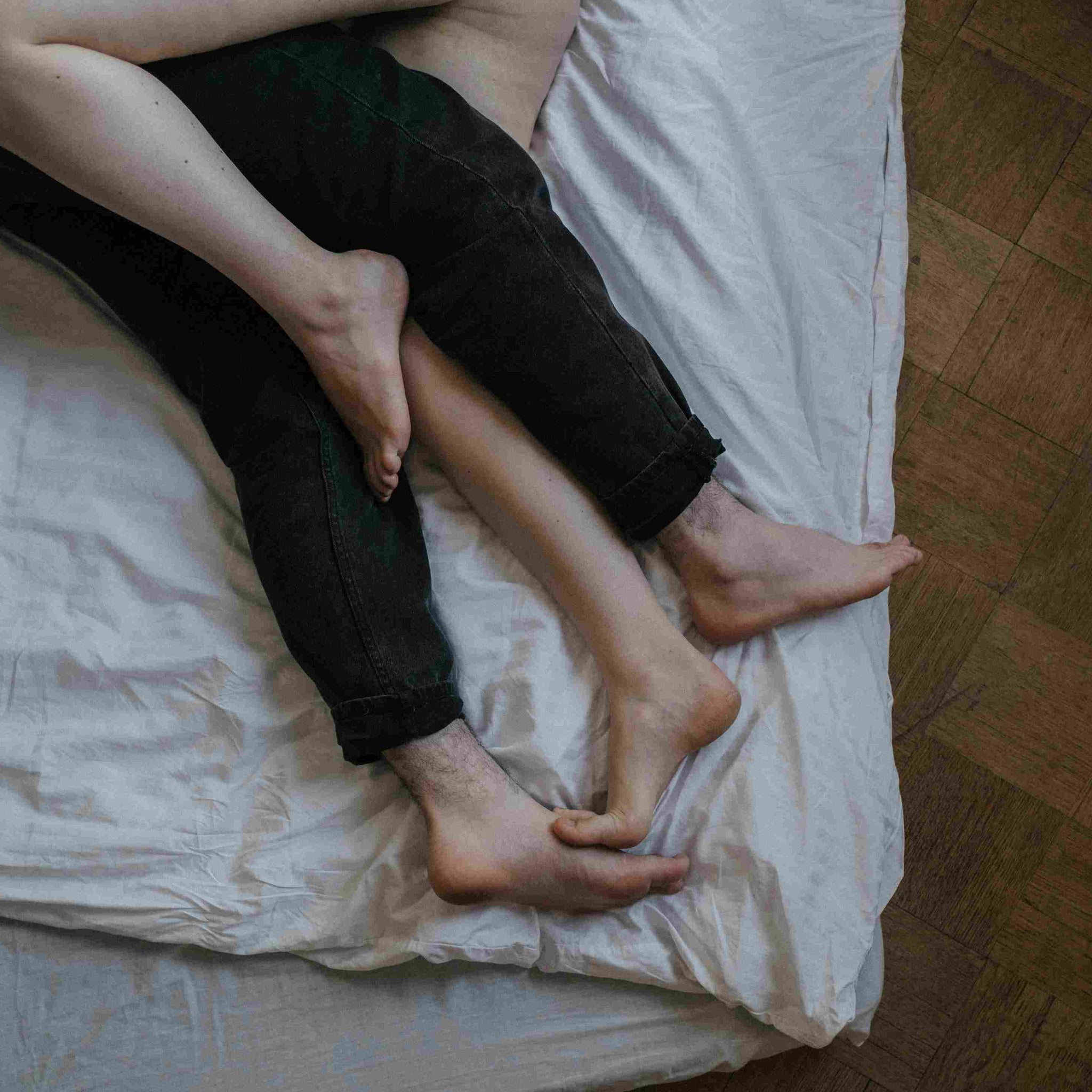 A woman and man lying in a bed